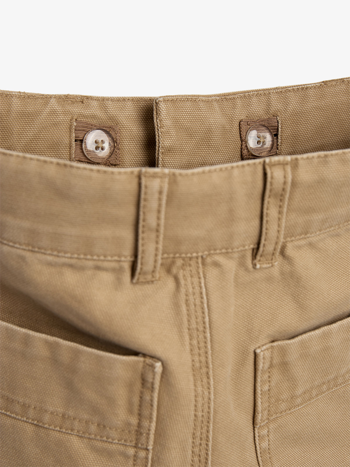 Khaki pants with an adjustable waist feature two buttons on tabs, surrounded by belt loops and pockets, in a plain white background.