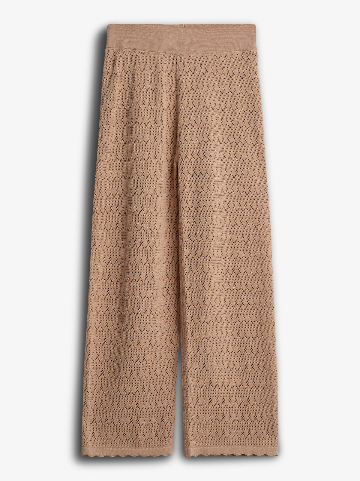 Tan crochet pants are displayed, featuring a zigzag pattern. They hang flat against a plain background, highlighting their wide-leg design and elastic waistband.