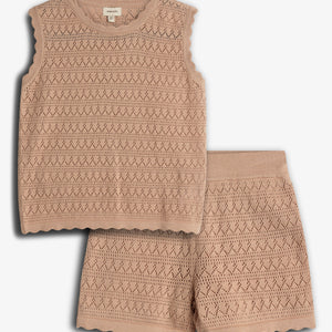 A knitted sleeveless top and shorts set in a beige color. The top features a diamond and zigzag pattern, alongside scalloped edges. It's laid on a plain light background.