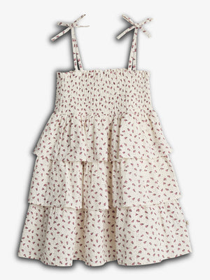 A floral-patterned, tiered dress with tied shoulder straps, featuring shirred bodice and layered ruffle skirt, displayed against a plain white background.