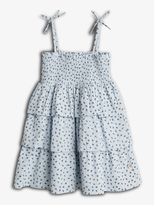 A light blue, floral-patterned dress with tiered ruffles and thin straps tied at the shoulders, displayed against a white background.