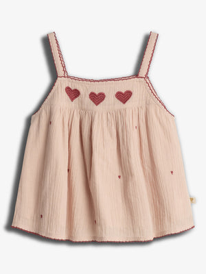 A light pink sleeveless top with red heart embroidery across the chest. It has thin straps and small scattered heart patterns, complementing a delicate, textured fabric.