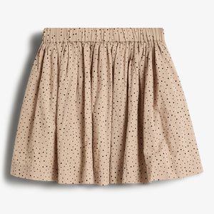 A beige skirt with black polka dots is displayed against a plain white background. The skirt features a gathered waistband and a pleated design, giving it a full appearance.