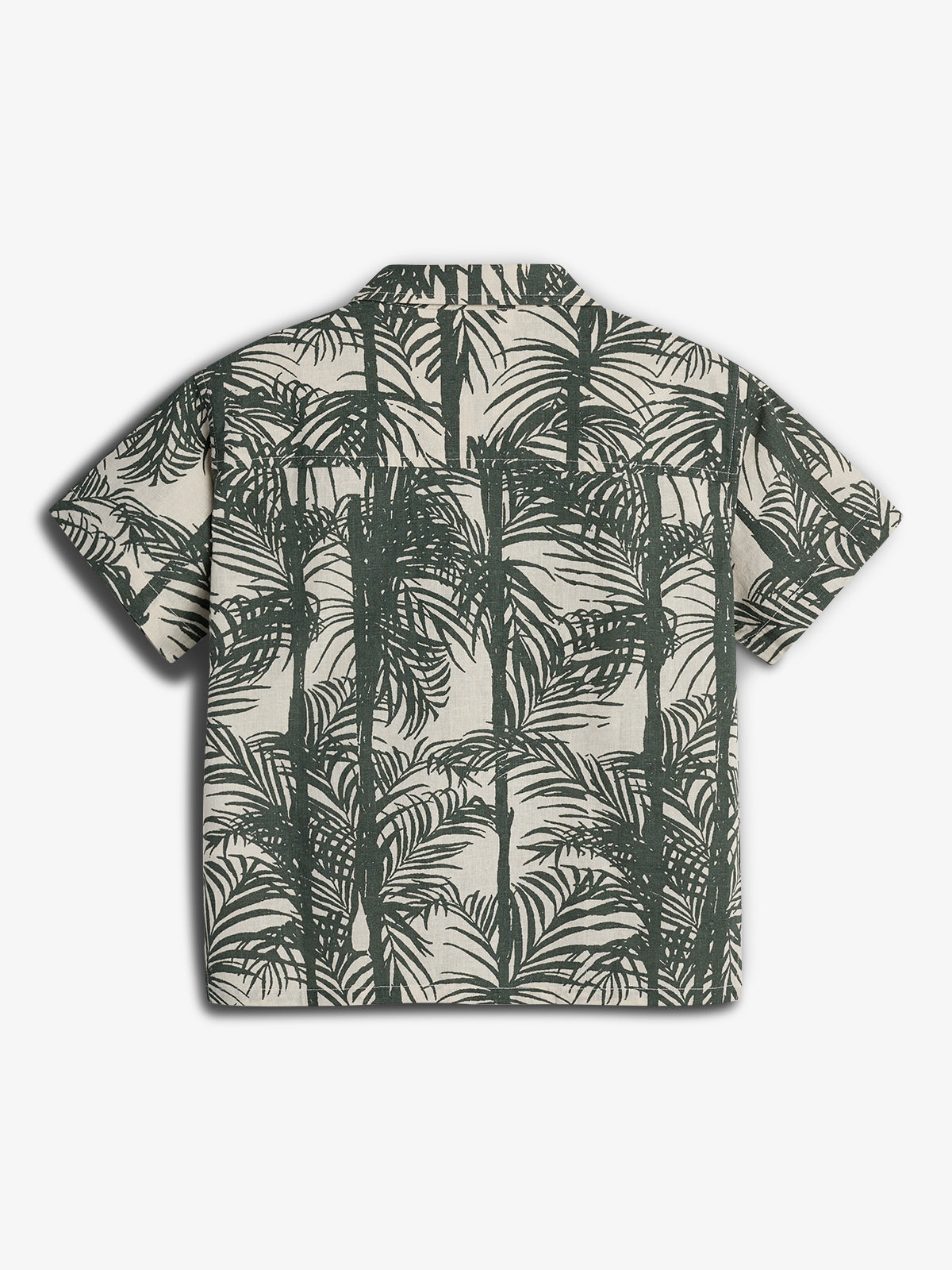 A short-sleeved shirt displays a green palm tree pattern on a cream background. It is laid flat against a plain white backdrop, emphasizing its casual, tropical design.