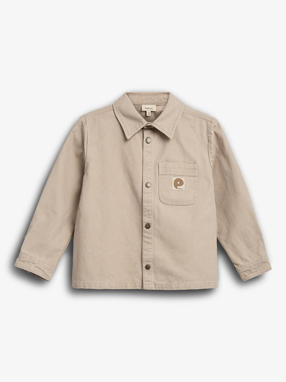 A beige button-up shirt with long sleeves and a collar, featuring a single chest pocket with a circular logo, is displayed against a plain white background.