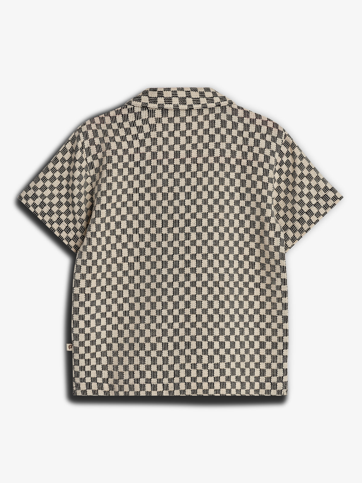 A short-sleeve shirt features a black and beige checkered pattern, laid flat against a plain white background, highlighting its design.