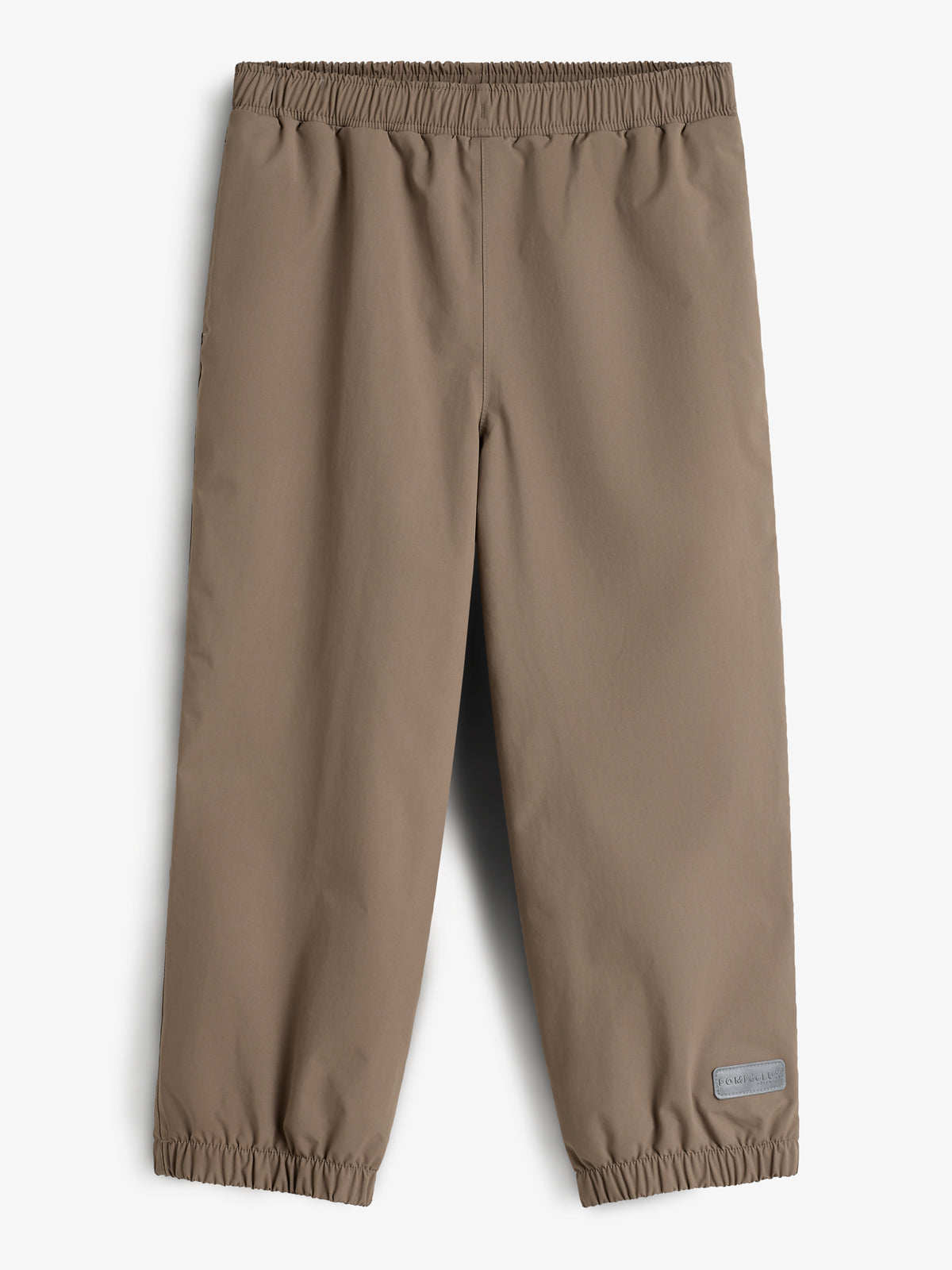 Een bruine regenbroek met elastische tailleband en enkels ligt plat. In de context van een lichte achtergrond. Rechtsonder is een grijs label te zien met de tekst: "Polarn O. Pyret."