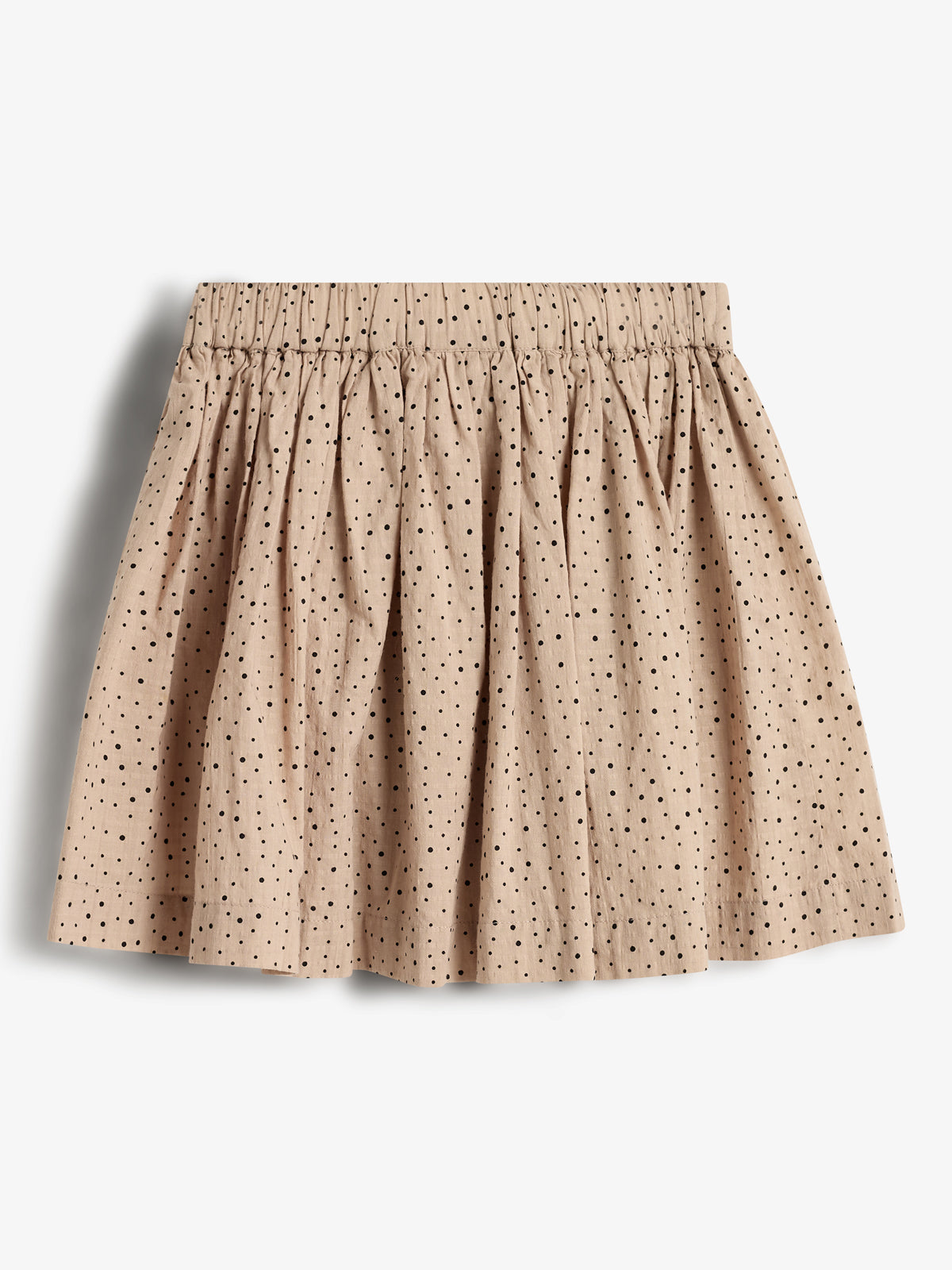 A beige skirt with black polka dots features an elastic waistband and a gathered, pleated design, displayed against a plain white background.